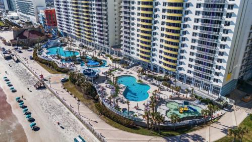 an aerial view of a water park in front of a tall building at Luxurious Oceanfront Haven, Newly Remodeled 1BR with All-New Furnishings at the Wyndham Ocean Walk in Daytona Beach