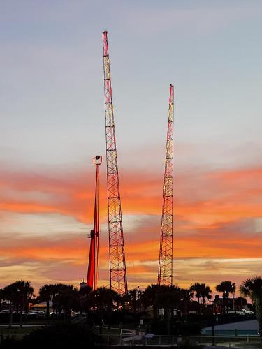 two tall towers with a sunset in the background at Luxurious Oceanfront Haven, Newly Remodeled 1BR with All-New Furnishings at the Wyndham Ocean Walk in Daytona Beach