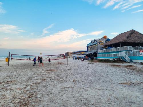 a group of people playing volleyball on the beach at Luxurious Oceanfront Haven, Newly Remodeled 1BR with All-New Furnishings at the Wyndham Ocean Walk in Daytona Beach
