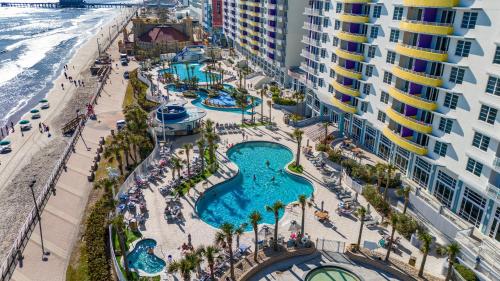 an aerial view of a resort with a pool and the ocean at Luxurious Oceanfront Haven, Newly Remodeled 1BR with All-New Furnishings at the Wyndham Ocean Walk in Daytona Beach