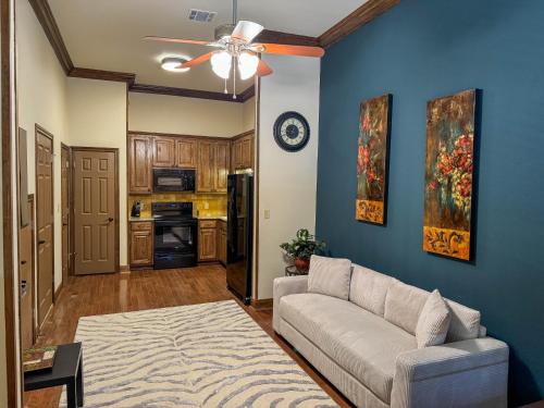 a living room with a couch and a ceiling fan at Bliss On The River in Llano