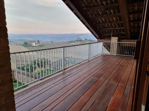 a balcony of a house with a wooden deck at Ca 'nsel Bric in Canelli