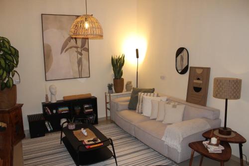 a living room with a couch and a table at Boho Style Cozy 1 BHK Apartment in Abu Dhabi