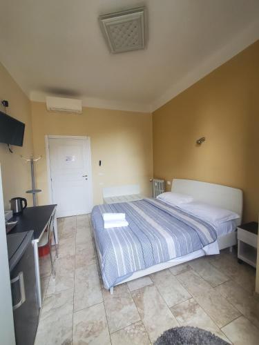a bedroom with a bed and a desk in it at Hotel Emmy in Milan