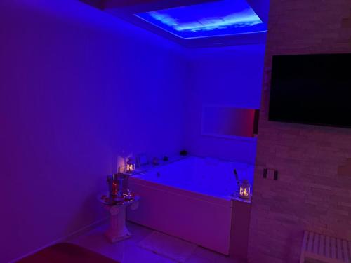 a purple bathroom with a tub and a tv at Terraforte Luxury Suite in Fisciano