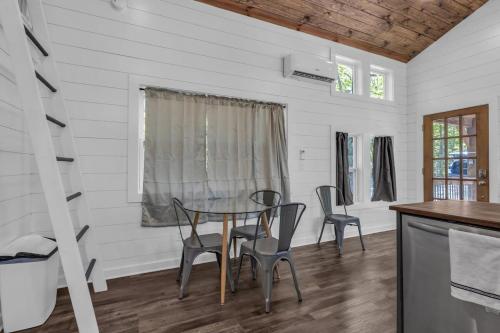 a dining room with a table and chairs at Menlo GA Tiny Home Experience in Rising Fawn