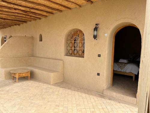 a room with a couch and a table and a window at Les Jardins de la Santé in Tamazouzte