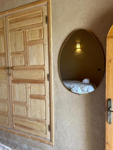 a room with a door and a mirror at Les Jardins de la Santé in Tamazouzte
