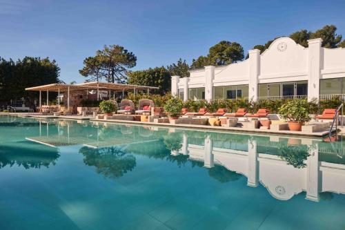 a pool at a hotel with blue water at Kimpton Los Monteros Marbella by IHG in Marbella