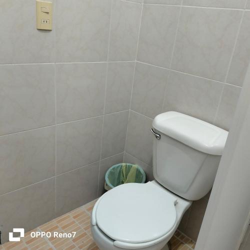 a bathroom with a white toilet and a trash can at Hotel San Jose Purua in Vidalrstn