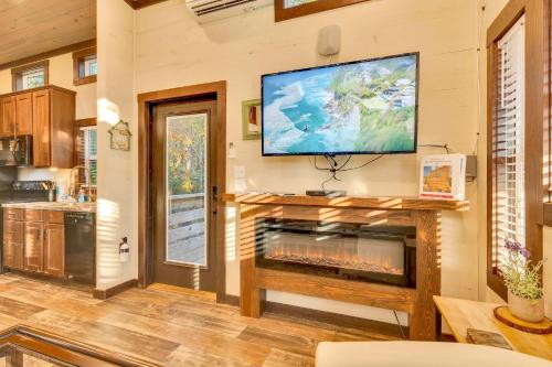 a living room with a fireplace and a flat screen tv at Firefly at Mentone with Hot Tub & Internet in Menlo