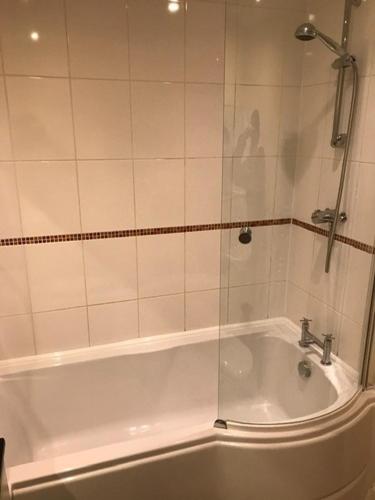 a bathroom with a shower and a bath tub at Lovely Furnished Apartment 2 in Carlisle