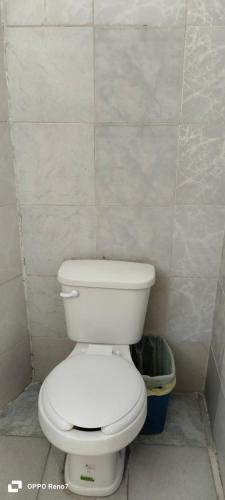 a bathroom with a white toilet and a trash can at Hotel San Jose Purua in Vidalrstn