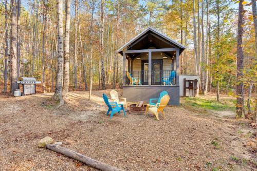 a cabin with chairs and a table in the woods at Dreamer at Mentone with Free Internet in Menlo