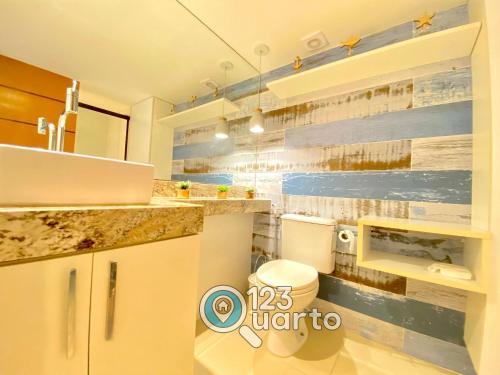 a bathroom with a toilet and a sink at Gold Flat Cabo Branco By 123Quarto Hospedagem in Tambaú