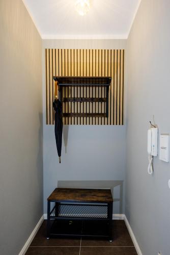 a room with a bench with an umbrella on the wall at UNiQE I Luxuriöses 145qm Apartment in Feldafing