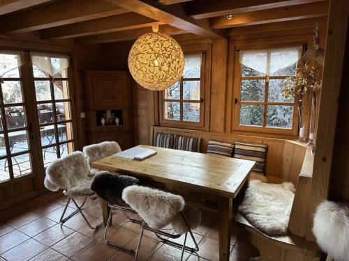 a dining room with a wooden table and chairs at Chalet Medonnet - CHALET 10 personnes Combloux MAE-7241 in Combloux