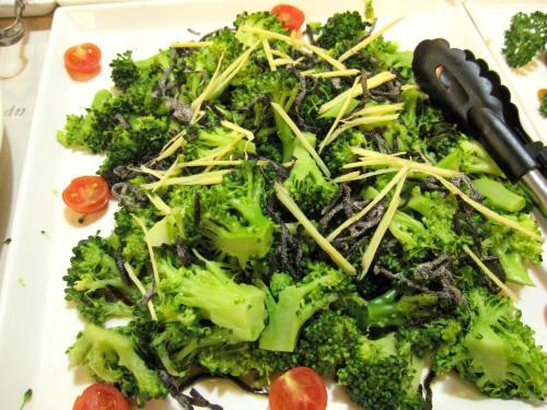 a plate of broccoli and tomatoes on a table at Toyohashi Station Hotel in Toyohashi