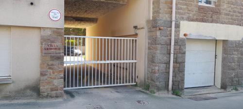 an entrance to a building with a white gate at Ker gwelanig in Trégastel
