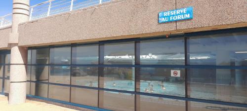 a building with a swimming pool inside of it at Ker gwelanig in Trégastel