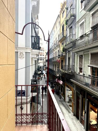 a view from a balcony of a street with buildings at Mercat Suites in Valencia