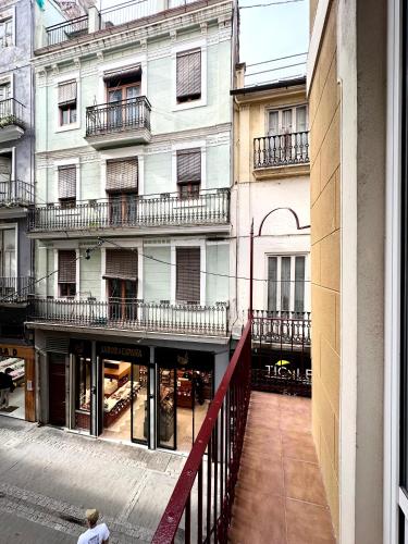 a man walking down a street in front of a building at Mercat Suites in Valencia