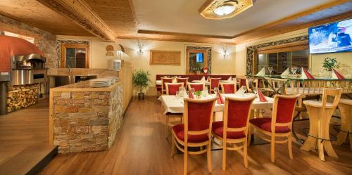 a restaurant with a table and chairs and a bar at Hotel Duc De Rohan in Livigno