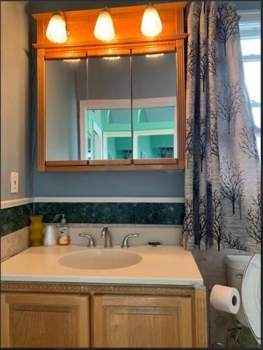 a bathroom with a sink and a mirror at Sunshine Motel in Wildwood