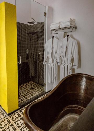 a bathroom with a wooden tub and a shower at Elena de Cobre, Leon, a Member of Design Hotels in León