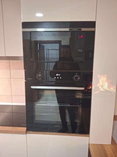 a person is standing inside of an oven at Apartmani Marjanovic in Jagodina