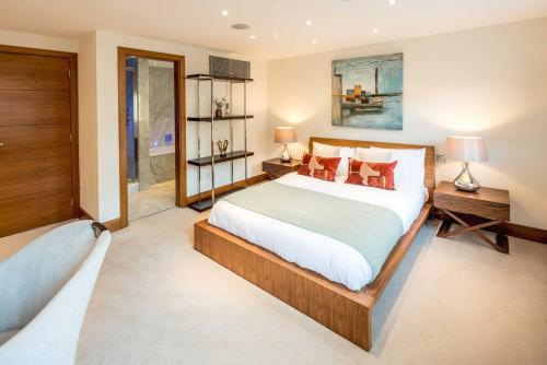 a bedroom with a large bed and a window at -Air con- Luxury Townhouse - High St Kensington! in London