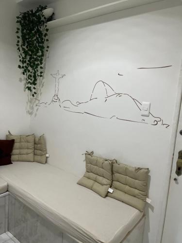 a bench in a room with a drawing on the wall at Praia de Botafogo vista Pão de Açúcar in Rio de Janeiro