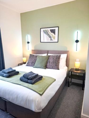 a bedroom with a bed with two towels on it at Modern Newly Refurbished 3-Bedroom House in Lincoln