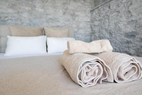 a bed with white pillows and blankets on it at Casa Morena - Private Tropical Oasis in Campanário