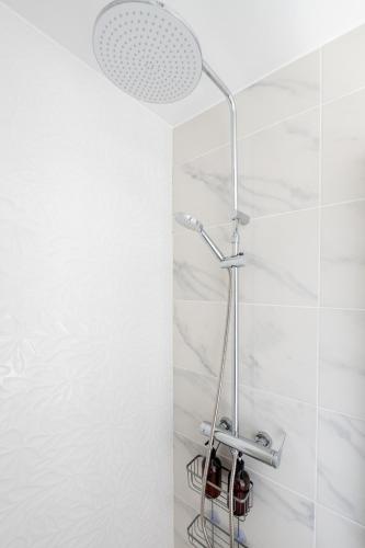 a shower with a shower head in a bathroom at Casa Morena - Private Tropical Oasis in Campanário