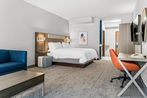 a hotel room with a bed and a desk at Holiday Inn Express & Suites - Detroit Northwest - Livonia by IHG in Livonia