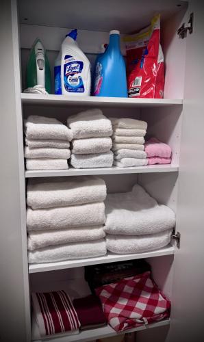 a closet filled with towels and other cleaning products at Choo Choo Inn in Elkhart