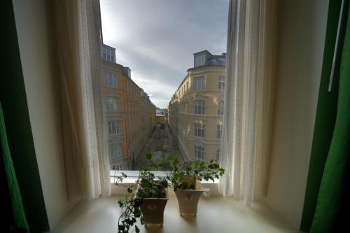 a view of a city from a window with potted plants at Go Hotel Ansgar in Copenhagen