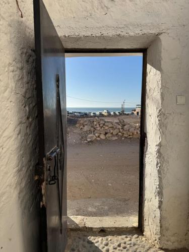 an open door with a view of the desert at La Porte sur l'océan in Sidi Kaouki