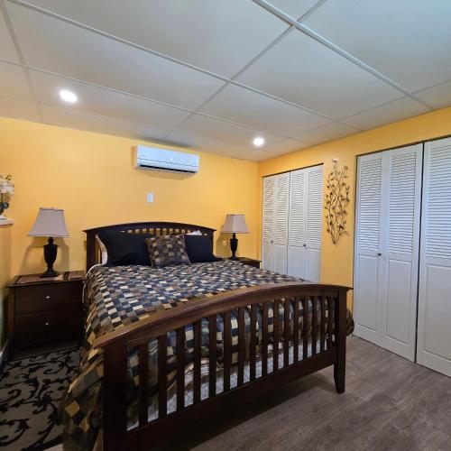 a bedroom with a wooden bed and yellow walls at Ocean's Edge in Port Alice