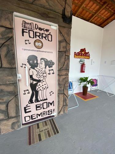 a sign for an event in a room at Pousada Santo Amaro in Santo Amaro