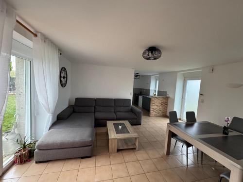 a living room with a couch and a table at Charmante maison en pierre in Saint-Eutrope