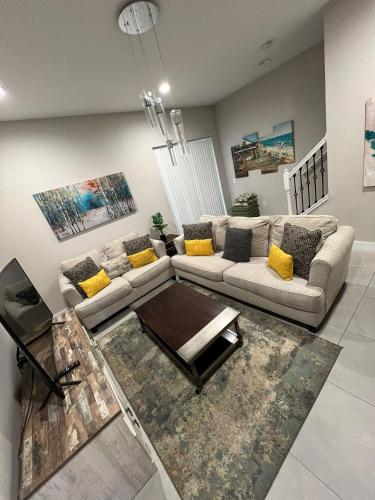 a living room with a couch and a table at Disney here we go in Orlando