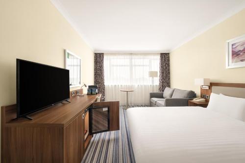 a hotel room with a bed and a flat screen tv at Holiday Inn York by IHG in York