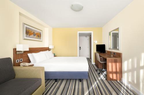 a hotel room with a bed and a desk at Holiday Inn York by IHG in York