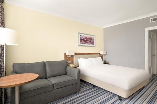 a hotel room with a bed and a couch at Holiday Inn York by IHG in York