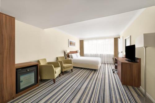 a hotel room with a bed and a television at Holiday Inn York by IHG in York