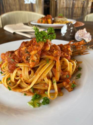 a plate of pasta on a white plate at Palaa Mayapo Ecolodge in Mayapo
