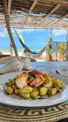 a plate of food with shrimp and potatoes on a table at Palaa Mayapo Ecolodge in Mayapo
