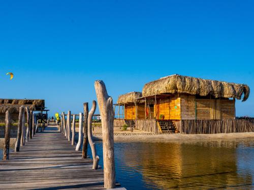 a building on a pier next to the water at Palaa Mayapo Ecolodge in Mayapo